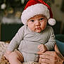 Leyon participe au concours pour gagner de l'argent avec cette photo : baby, child, christmas, chubby, clothing, cozy, cute, expression, festive, hand, holiday, indoor, infant, knitted_blanket, person, portrait, santa_hat, sitting, soft_lighting, support