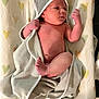 newborn, baby, infant, towel, blanket, heart_pattern, skin, hooded_towel, lying_down, small_hands, small_feet, cute, soft_texture, indoors, resting, wrapped, sleepwear, baby_skin, child, adorable