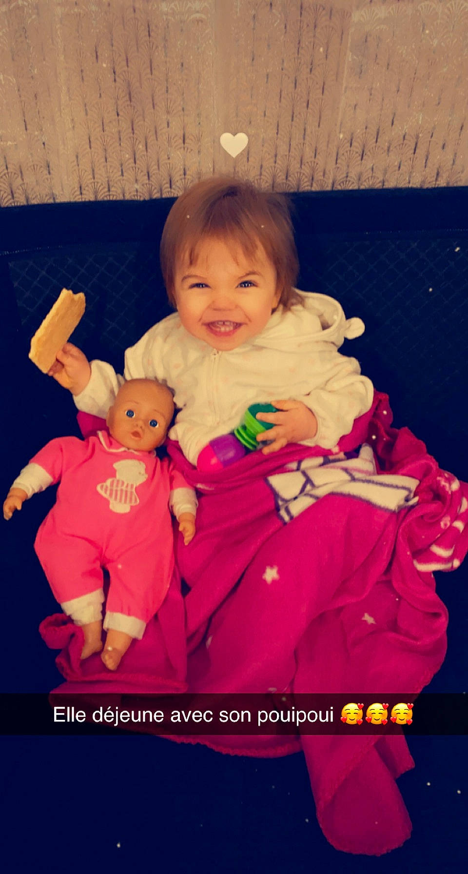 Maïssa participe au concours pour gagner de l'argent avec cette photo : arm, baby, baby_products, baby_toddler_clothing, child, doll, event, fun, gesture, happy, joy, magenta, person, pink, sitting, skin, sleeve, smile, textile, thumb