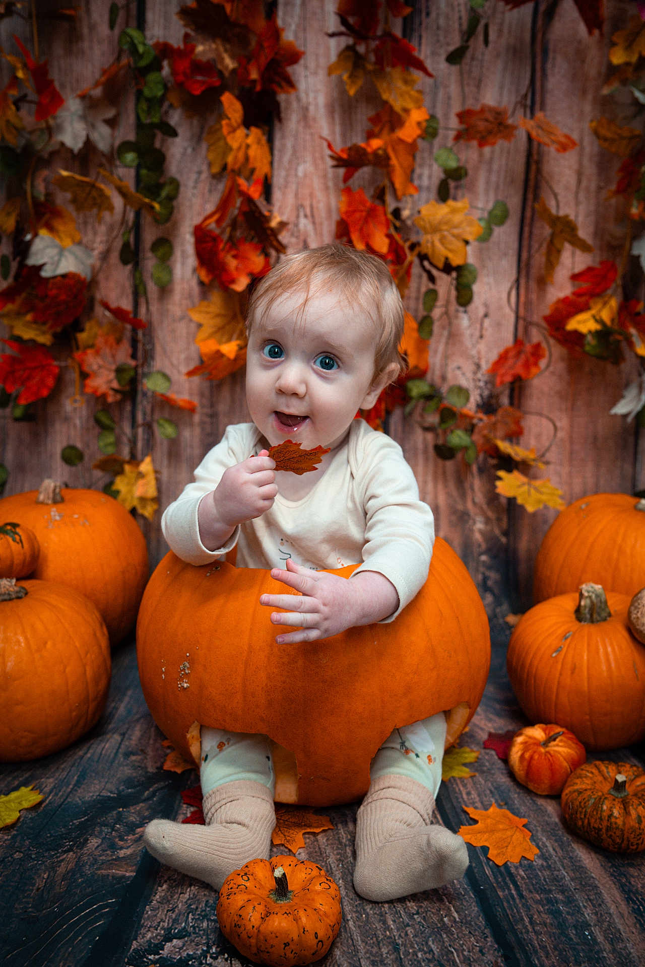 Isaac joined the competition — help win amazing prizes! baby, pumpkin, fall, autumn, leaf, orange, cute, child, seasonal, holiday, decor, smile, sitting, background, wood, floor, nature, festive, cozy, playful