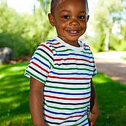 Souely participe au concours pour gagner de l'argent avec cette photo : child, boy, smiling, standing, outdoor, greenery, striped_tshirt, casual_clothing, short_hair, bracelet, jeans, happy, sunlight, nature, grass, park, portrait, daylight, person, young