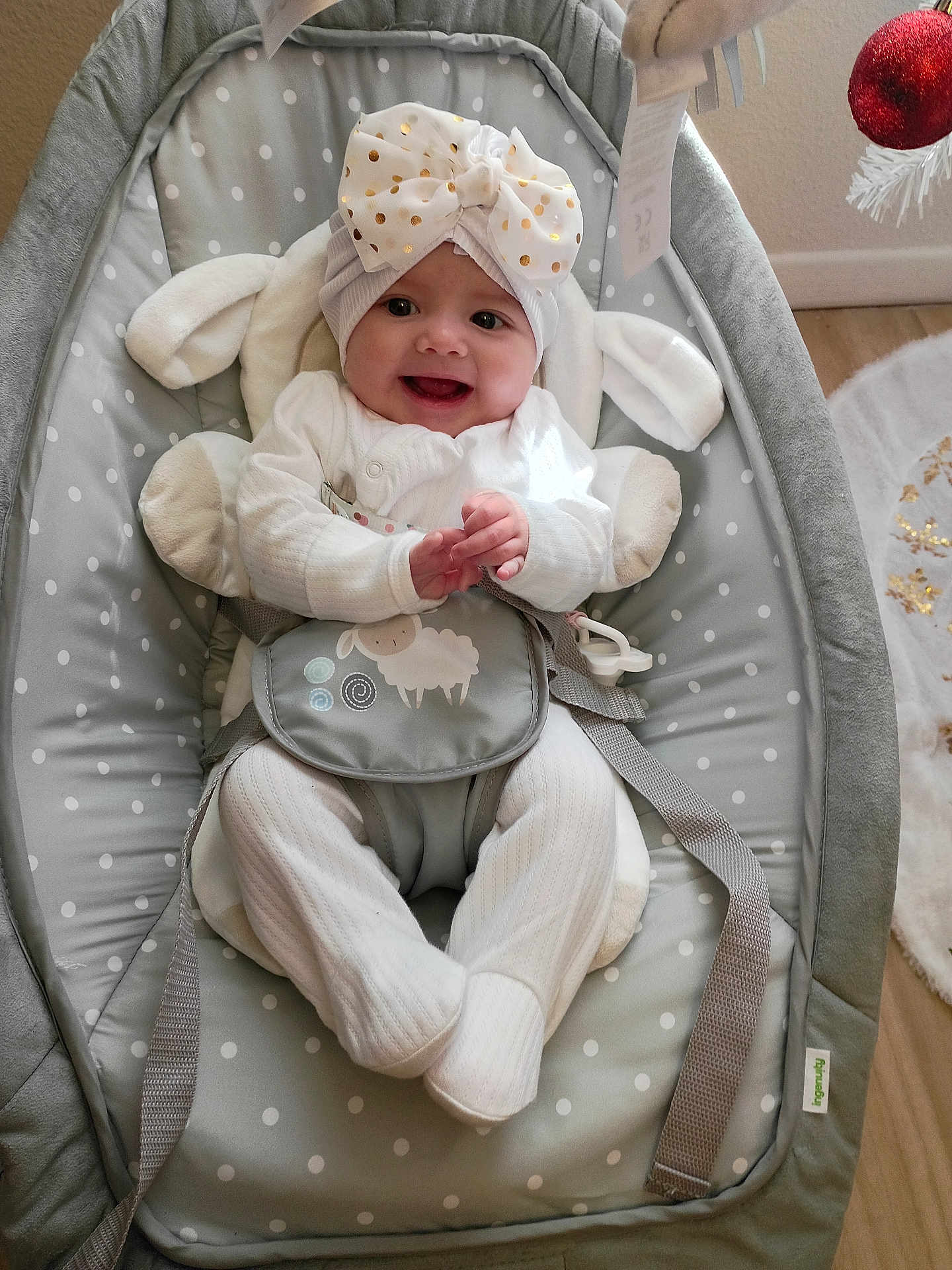 Lanessalee joined the competition — help win amazing prizes! baby, infant, smiling, white_clothing, headband, bow, baby_bouncer, gray, polka_dot, indoor, happy, child, seat, floor, wood_floor, holiday_decor, christmas, ornament, cute, comfort