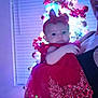 Lanessalee is registered to the contest to win money with this photo: baby, child, red_dress, headband, christmas_tree, holiday, ornaments, lights, indoor, person, festive, decorations, celebration, window_blinds, holding, smiling, cute, infant, portrait, family