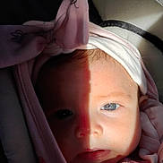 Lanessalee joined the competition — help win amazing prizes! baby, face, closeup, infant, pink_clothing, hood, bow, blue_eye, shadow, light, contrast, portrait, cute, child, soft_texture, newborn, warmth, expression, indoor, baby_clothes