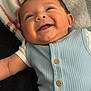Greyson joined the competition — help win amazing prizes! baby, smile, infant, blue_outfit, buttons, plaid_blanket, red_stripes, green_stripes, cozy, happy, portrait, cute, child, lying_down, soft_texture, closeup, skin, face, arm, buttoned_clothing