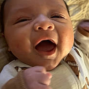 Greyson joined the competition — help win amazing prizes! baby, infant, smiling, face, closeup, hand, clothing, football_pattern, blanket, happy, newborn, cute, skin, mouth_open, eyes, portrait, child, indoors, soft_texture, lying_down