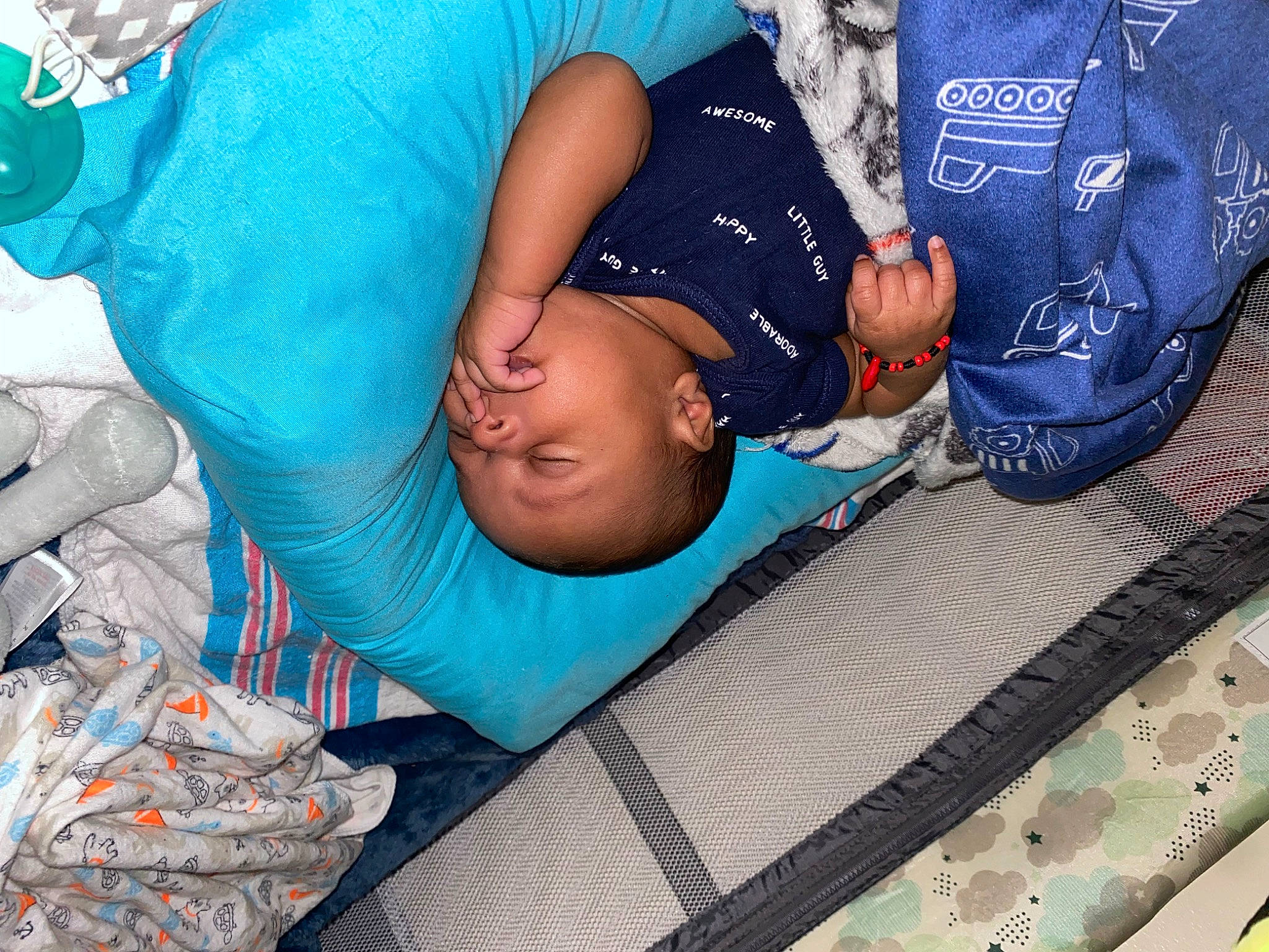 Luis is registered to the contest to win money with this photo: abdomen, blue, child, comfort, elbow, electric_blue, event, fun, hat, human_leg, knee, leisure, linens, pattern, person, shorts, sitting, t_shirt, textile, thigh