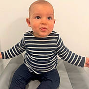 Raphaël participe au concours pour gagner de l'argent avec cette photo : baby, casual_clothing, child, curious_expression, cute, eyes, face, head, indoor, navy_pants, padded_surface, person, playful, portrait, sitting, skin, smiling, striped_shirt, toddler, young
