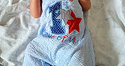 Darius is registered to the contest to win money with this photo: baby, infant, smile, blue_outfit, blanket, lying_down, happy, cute, newborn, portrait, small_hands, feet, cozy, soft_texture, celebration, first_birthday, child, clothing, fabric, resting