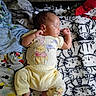 baby, sleeping, yellow_clothing, winnie_the_pooh, blanket, cat_pattern, soft_fabric, infant, peaceful, resting, cute, toddler, indoors, portrait, child, comfort, nap, small_child, lying_down, cozy