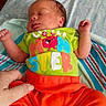 newborn, baby, sleeping, infant, clothing, green_shirt, orange_pants, hand, blanket, bed, resting, peaceful, cute, portrait, indoors, colorful, soft, patterned, child, human