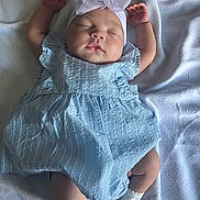 Gianna joined the competition — help win amazing prizes! baby, sleeping, blue_dress, headband, white_bow, socks, blanket, infant, child, cute, peaceful, soft_light, portrait, indoors, resting, newborn, hands_up, sleep, adorable, cozy