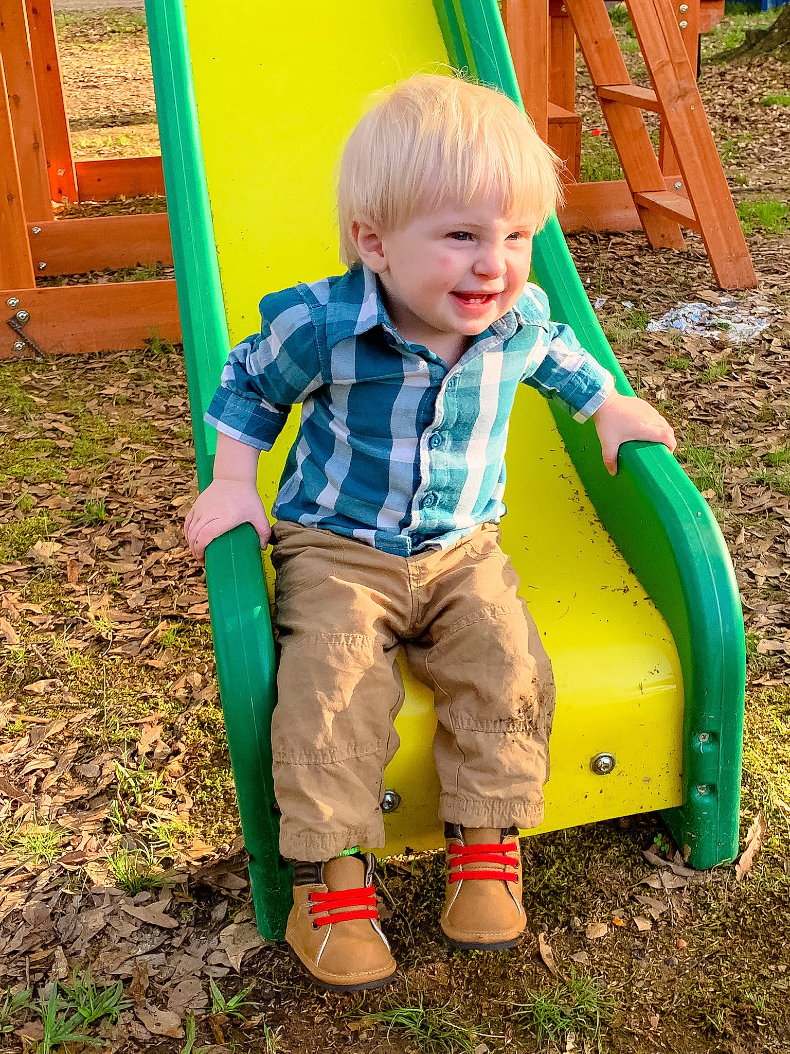 Gatlin is registered to the contest to win money with this photo: backyard, child, fun, grass, green, outdoor_play_equipment, person, play, playground, public_space, recreation, sitting, toddler