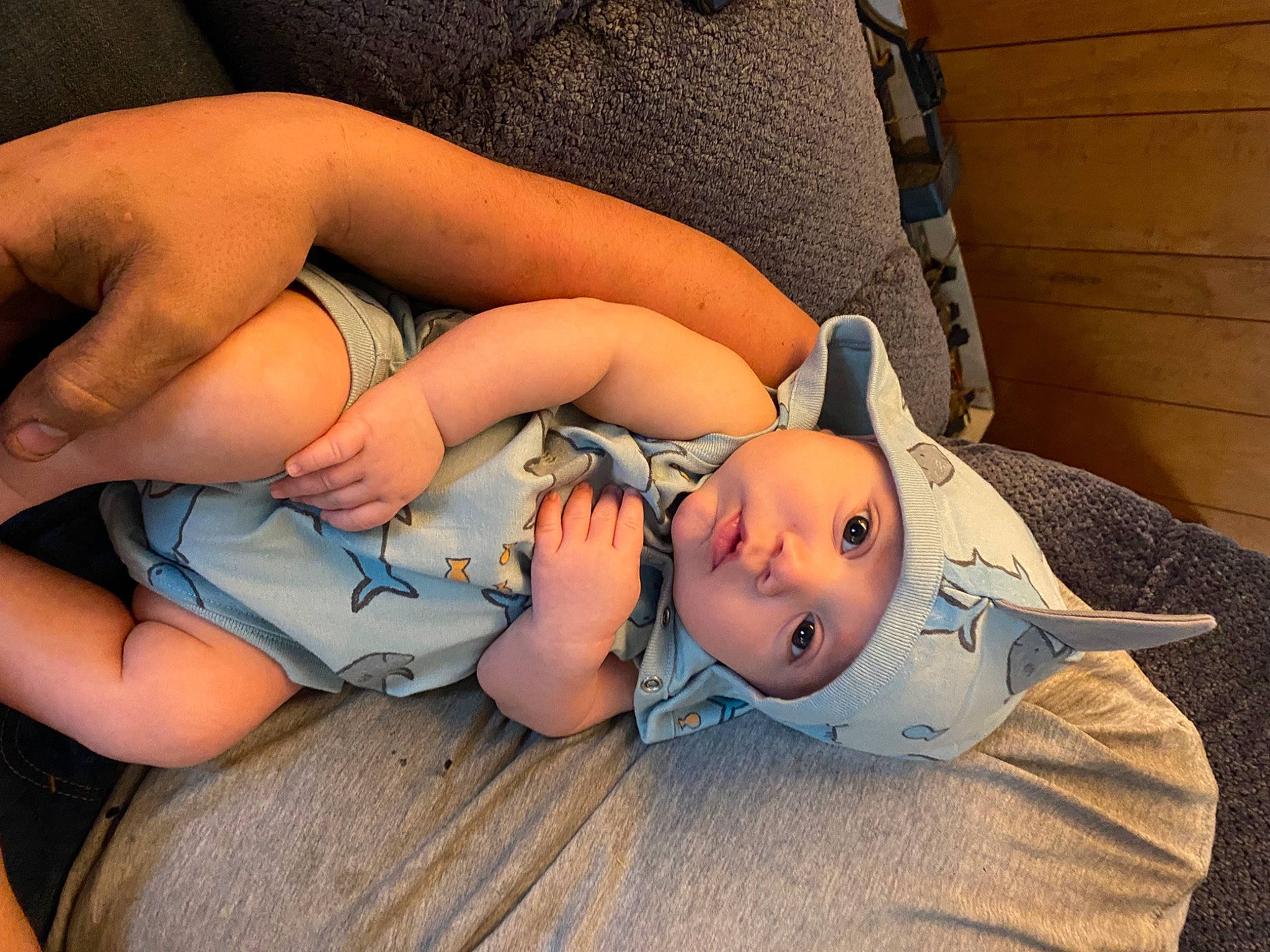 Clayton John is registered to the contest to win money with this photo: arm, azure, baby, comfort, eye, facial_expression, finger, gesture, hand, head, headgear, headwear, human_body, joint, leg, mouth, person, skin, textile, toddler