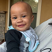 Jalynn joined the competition — help win amazing prizes! baby, smile, child, face, bib, clothing, person, holding, happy, indoor, portrait, cute, young, skin, hand, sleeve, fabric, clip, closeup, head