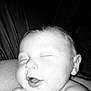 baby, sleeping, close_up, black_and_white, infant, peaceful, face, skin, hand, mouth, ear, child, newborn, rest, portrait, soft_light, calm, expression, human, cuddle