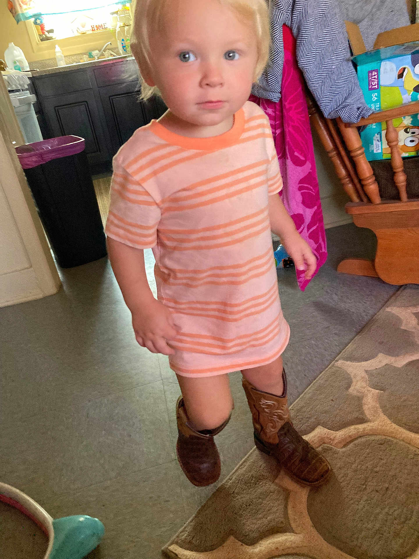 Kaliber joined the competition — help win amazing prizes! child, indoor, boy, striped_shirt, cowboy_boots, carpet, rug, floor, furniture, kitchen, cabinet, curious, standing, person, home, clothing, footwear, light, blond_hair, casual