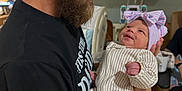 Blakelynn Elizabeth is registered to the contest to win money with this photo: man, baby, newborn, hospital, beard, smile, holding, bow_hat, medical_equipment, bed, black_shirt, infant, portrait, indoor, care, family, love, person, clothing, warmth