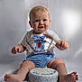Kaijay joined the competition — help win amazing prizes! baby, child, birthday_cake, cake, blue_shorts, suspenders, smiling, sitting, first_birthday, celebration, cute, portrait, indoor, light_background, happy, face, feet, hands, clothing, toddler