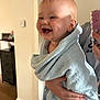 Kaijay is registered to the contest to win money with this photo: baby, child, towel, smile, indoor, person, hand, blue, happy, cute, infant, holding, face, portrait, clothing, skin, light, room, warmth, expression