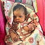 baby, blanket, car_seat, child, clothing, cozy, cute, fabric, face, hands, indoor, infant, newborn, pattern, person, pink, portrait, seated, soft_texture, warm