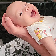 Amayah is registered to the contest to win money with this photo: baby, blanket, closeup, clothing, cute, fabric, face, hand, happy, holding, infant, infant_clothing, pattern, person, piglet, portrait, skin, smiling, star_wars, winnie_the_pooh