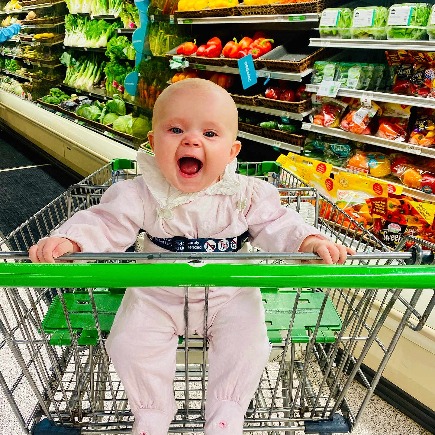 Serenity is registered to the contest to win money with this photo: baby, babylaughing, basket, clothing, face, footwear, grocerystore, happy, head, indoors, market, pants, person, photography, portrait, shoe, shop, shopping, shoppingcart, supermarket