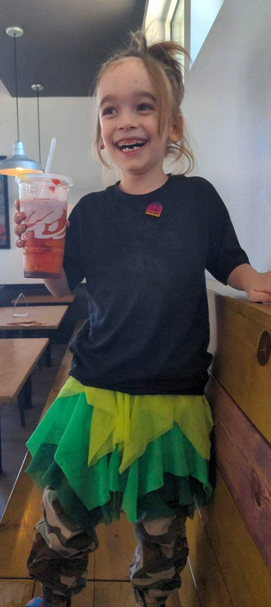 Kieran is registered to the contest to win money with this photo: child, cooking, costume, electric_blue, event, fashion_design, fun, happy, jewellery, joy, pattern, person, room, ruffle, sleeve, smile, standing, t_shirt, table, top