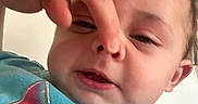 Sophie is registered to the contest to win money with this photo: baby, child, face, hand, nose, playful, expression, indoor, clothing, colorful, person, closeup, portrait, cute, young, skin, head, sitting, funny, family