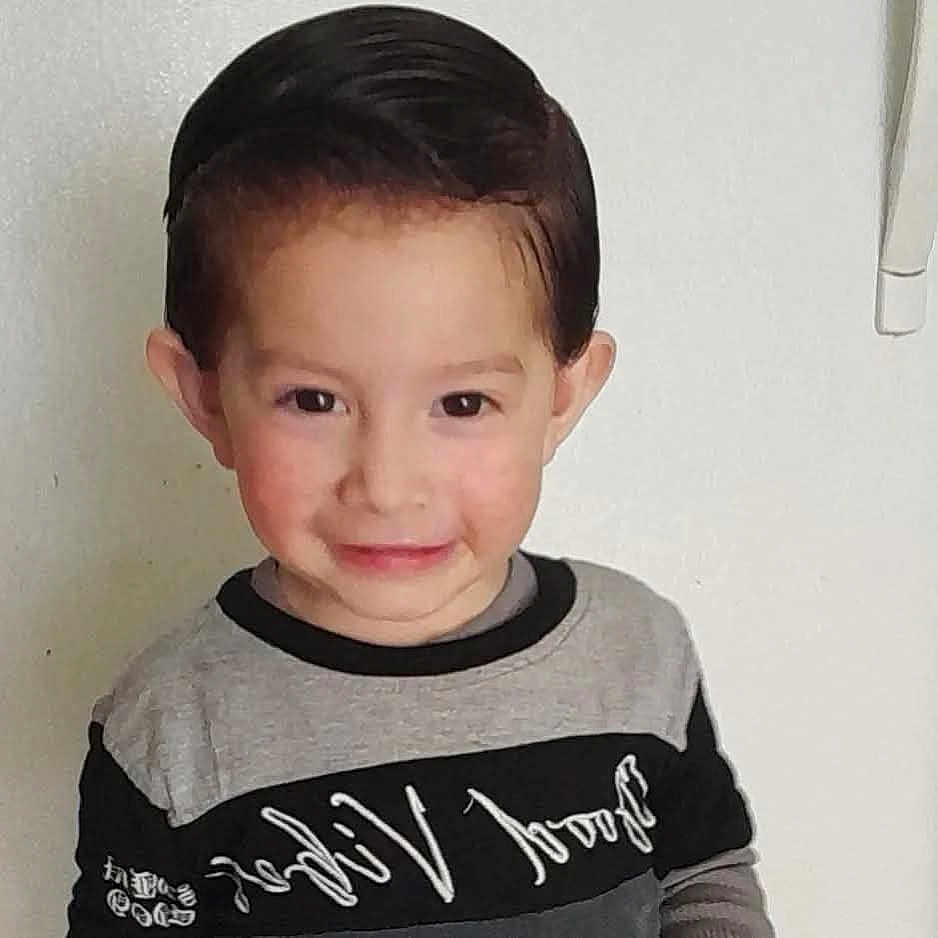 Dominique is registered to the contest to win money with this photo: boy, casual_clothing, child, cute, expression, eyebrows, eyes, face, friendly, hair, indoor, neatly_combed_hair, person, portrait, shirt, skin, smile, standing, white_wall, young