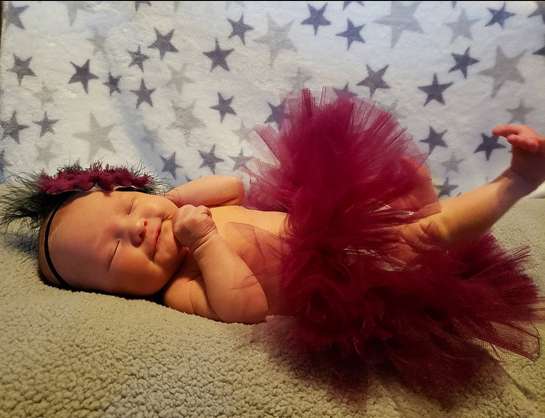 Eryn joined the competition — help win amazing prizes! baby, barefoot, bed, comfort, fashion_accessory, fawn, finger, flooring, fun, fur, gesture, grass, happy, headpiece, human_leg, linens, magenta, person, pink, room