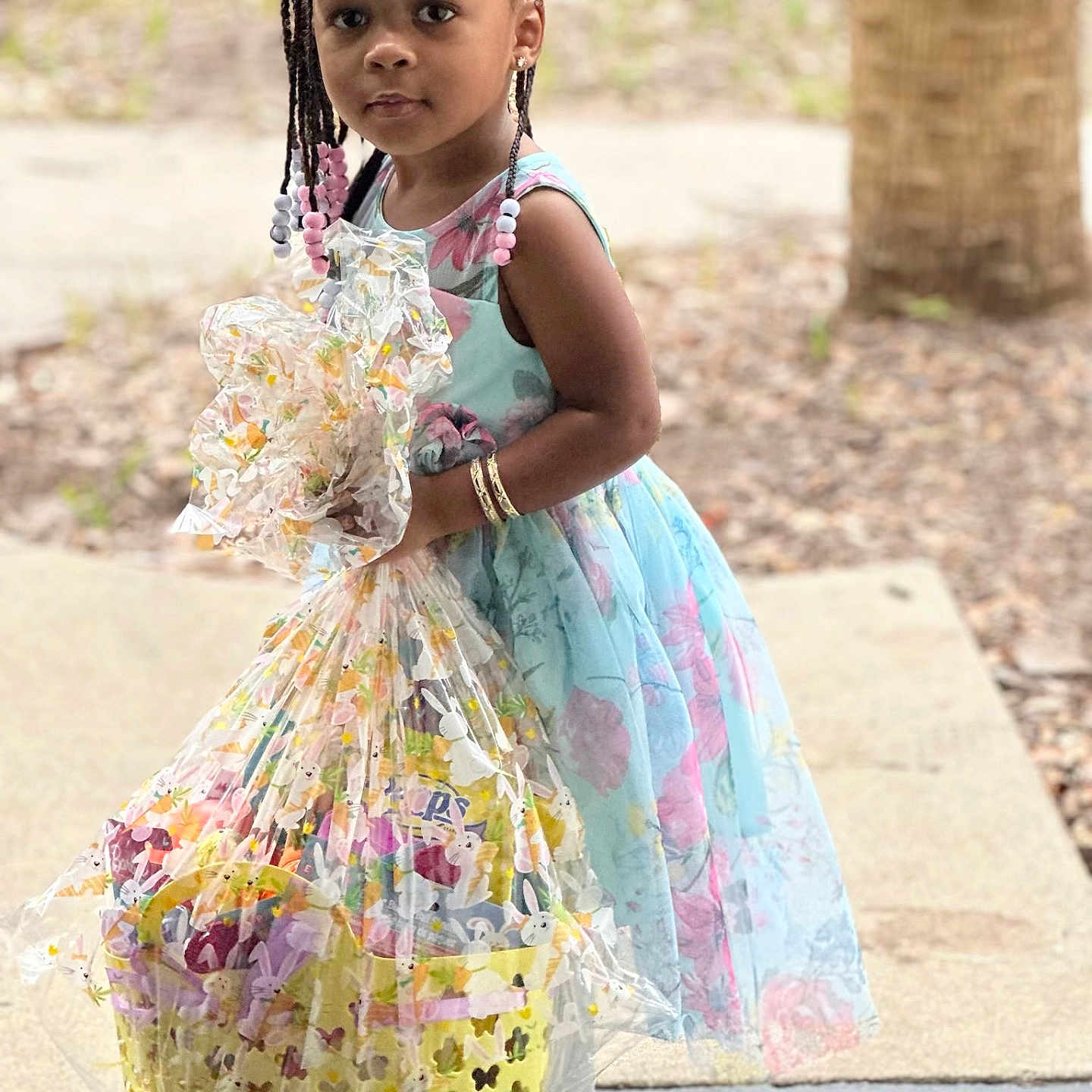 Koa is registered to the contest to win money with this photo: blackhair, braid, child, clothing, cornrows, dress, face, female, girl, hair, head, person, racket, sitting, sleeve, sport, standing, student, tennis, tennisracket