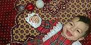 Ashely joined the competition — help win amazing prizes! baby, carpet, celebration, child, christmas_ornaments, cute, decorations, face, festive, happy, holiday, indoor, infant, lace, lying_down, pattern, person, plaid, red_dress, smiling