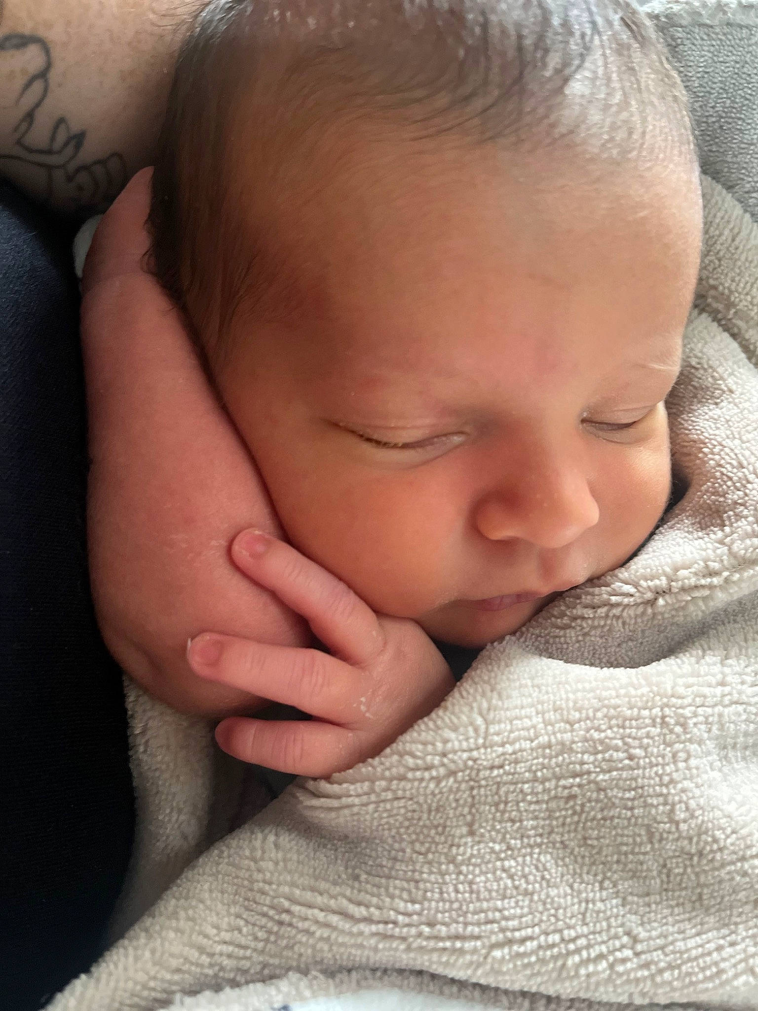 Wynston is registered to the contest to win money with this photo: baby, baby_toddler_clothing, cheek, chin, close_up, comfort, ear, eye, eyebrow, eyelash, gesture, hand, linens, lip, mouth, neck, nose, person, skin, thumb