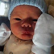 Oakley joined the competition — help win amazing prizes! newborn, baby, infant, hat, mittens, clothing, face, portrait, cute, tiger_cartoon, blanket, sleepwear, indoors, closeup, soft_lighting, expression, human, child, baby_clothes, swaddled