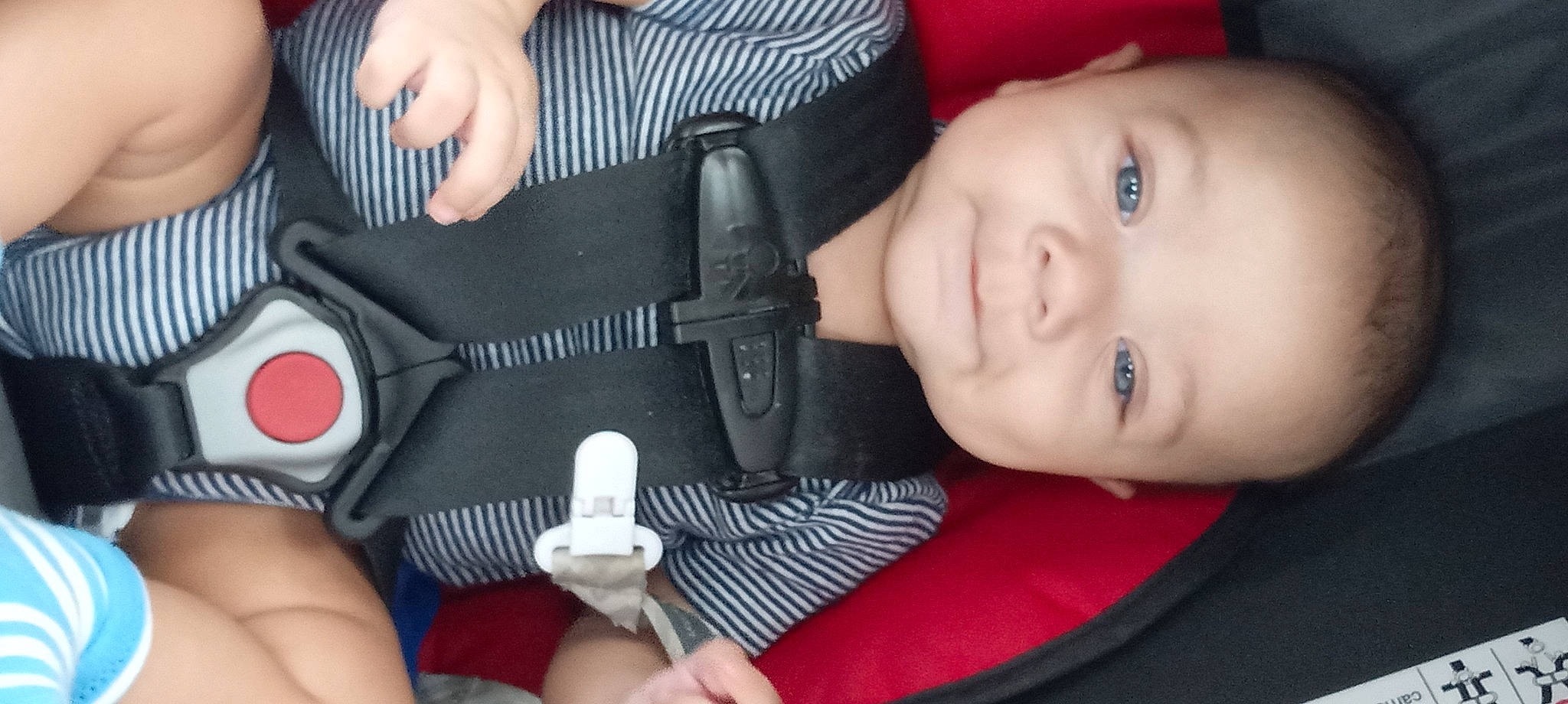 Gideon is registered to the contest to win money with this photo: auto_part, baby_toddler_clothing, car_seat, cheek, child, comfort, cool, eyelash, finger, gesture, glove, hand, human_body, nail, nose, person, skin, smile, snapshot, thumb