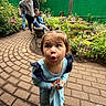 bench, blue_dress, brick_path, casual_clothing, child, children, curious, expression, flowers, garden, greenhouse, indoor, nature, path, people, person, pigtails, plants, shoes, toddler