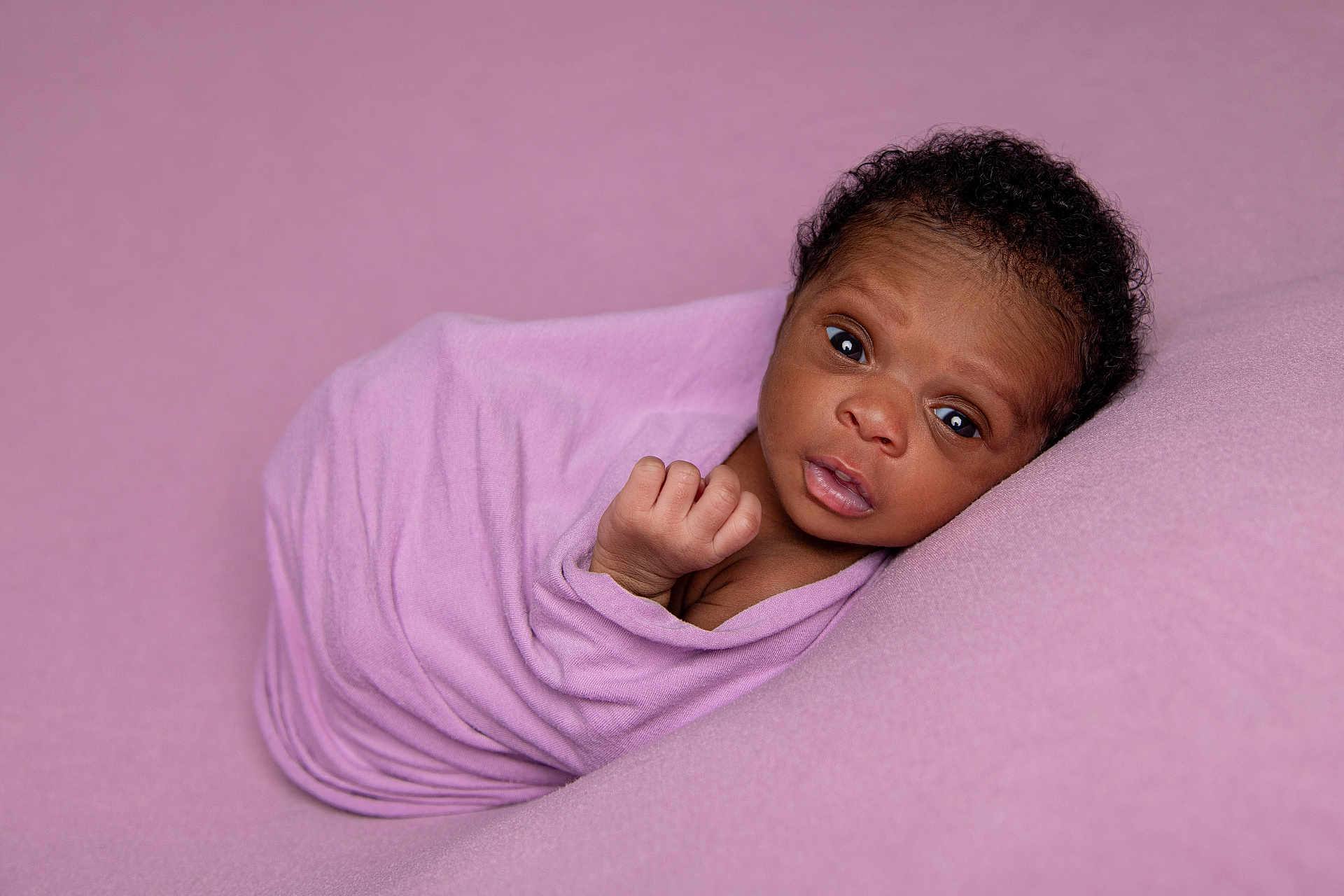 Lillian joined the competition — help win amazing prizes! newborn, baby, infant, wrapped, blanket, purple, soft, cute, lying, portrait, face, hand, curious, young, child, skin, head, sleeping_area, closeup, cozy