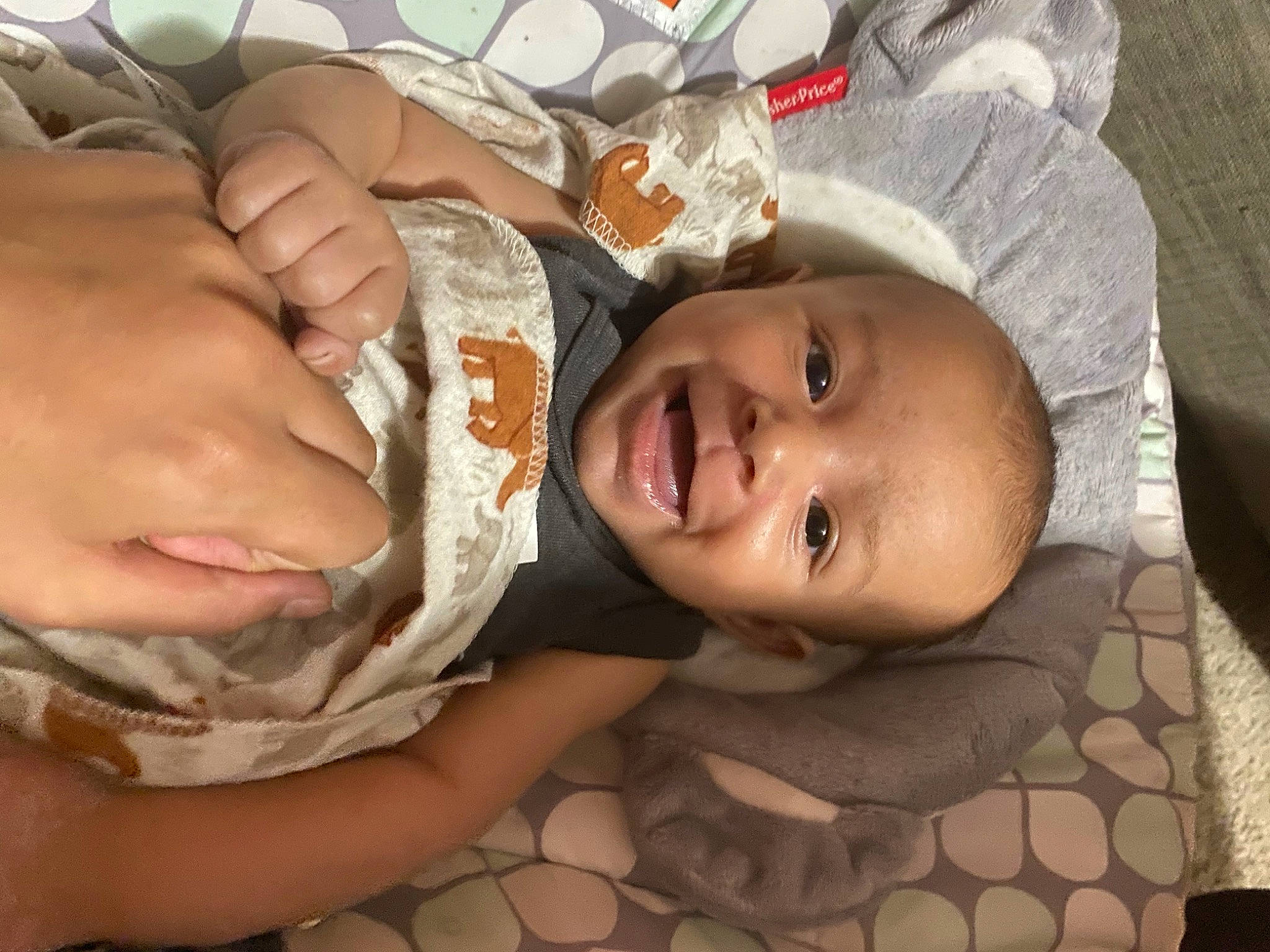 Tuff is registered to the contest to win money with this photo: baby, baby_toddler_clothing, cheek, chest, child, comfort, flesh, fun, gesture, happy, hat, human_body, linens, mouth, nose, pattern, person, skin, smile, thumb