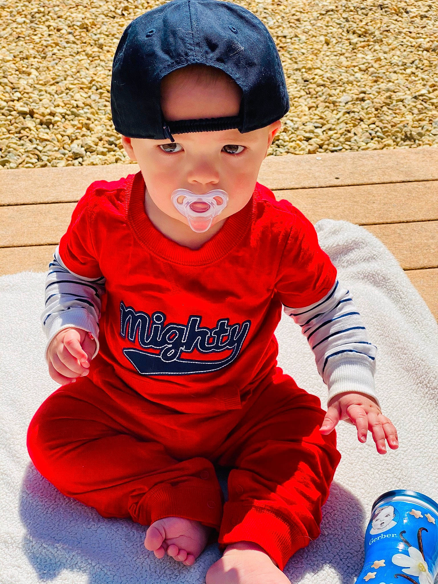 Malcolm is registered to the contest to win money with this photo: baby, blue, child, child_model, cool, fashion_accessory, head, headband, headgear, jeans, outerwear, people, person, play, red, sitting, sleeve, smile, t_shirt, textile