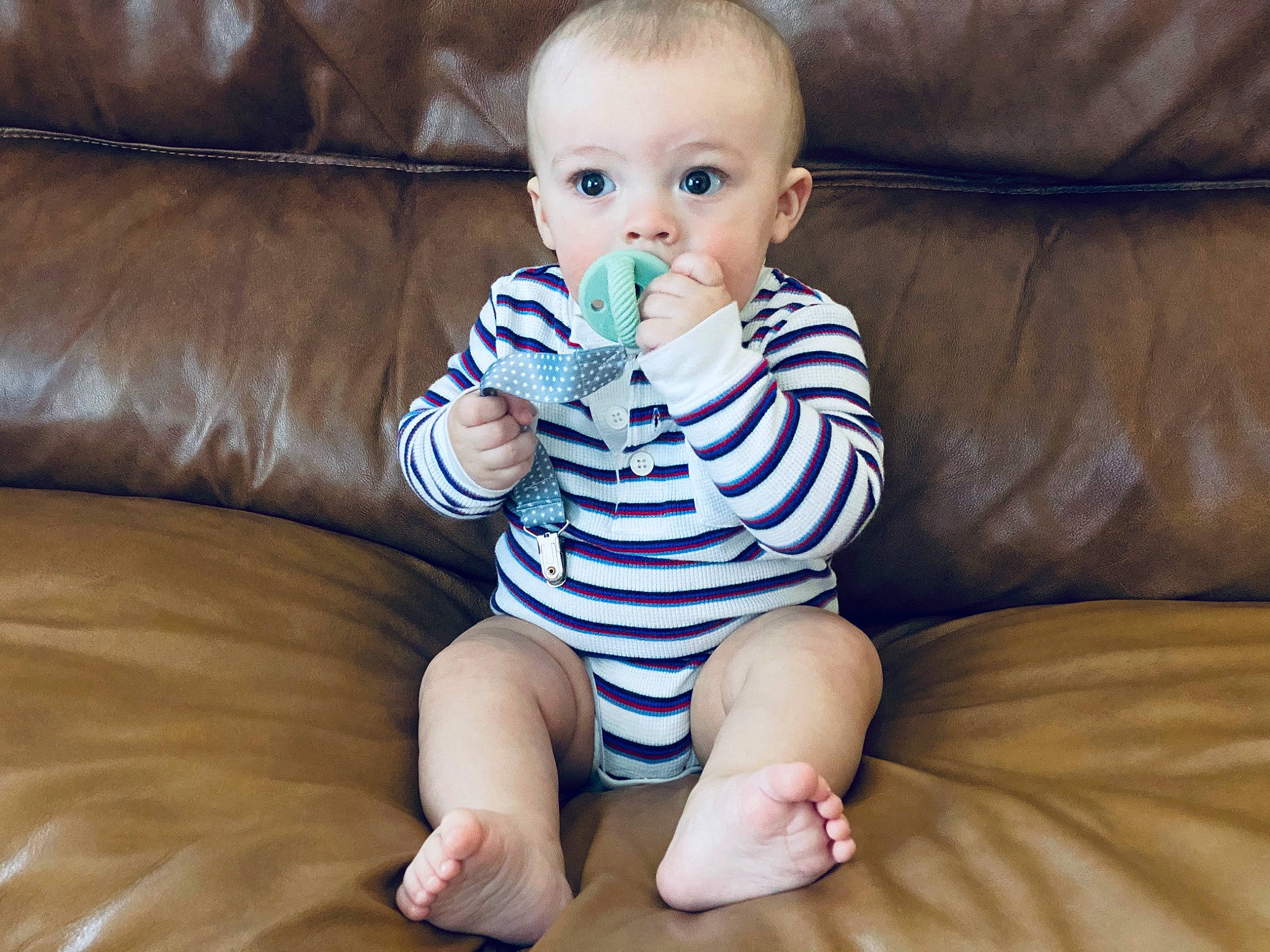 Malcolm is registered to the contest to win money with this photo: baby, baby_products, baby_toddler_clothing, barefoot, child, finger, leg, person, play, product, sitting, toddler