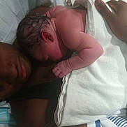 Ashanti Singleton is registered to the contest to win money with this photo: newborn, baby, adult, skin, hospital, towel, bed, resting, closeup, human, person, skin_to_skin, care, postpartum, mother, father, love, intimacy, hospital_gown, family