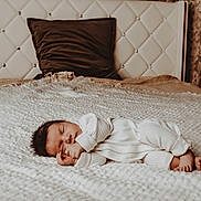 Everett is registered to the contest to win money with this photo: baby, newborn, sleeping, bed, blanket, pillow, headboard, indoors, cozy, white, soft, peaceful, infant, clothing, foot, hand, portrait, rest, cute, relaxation