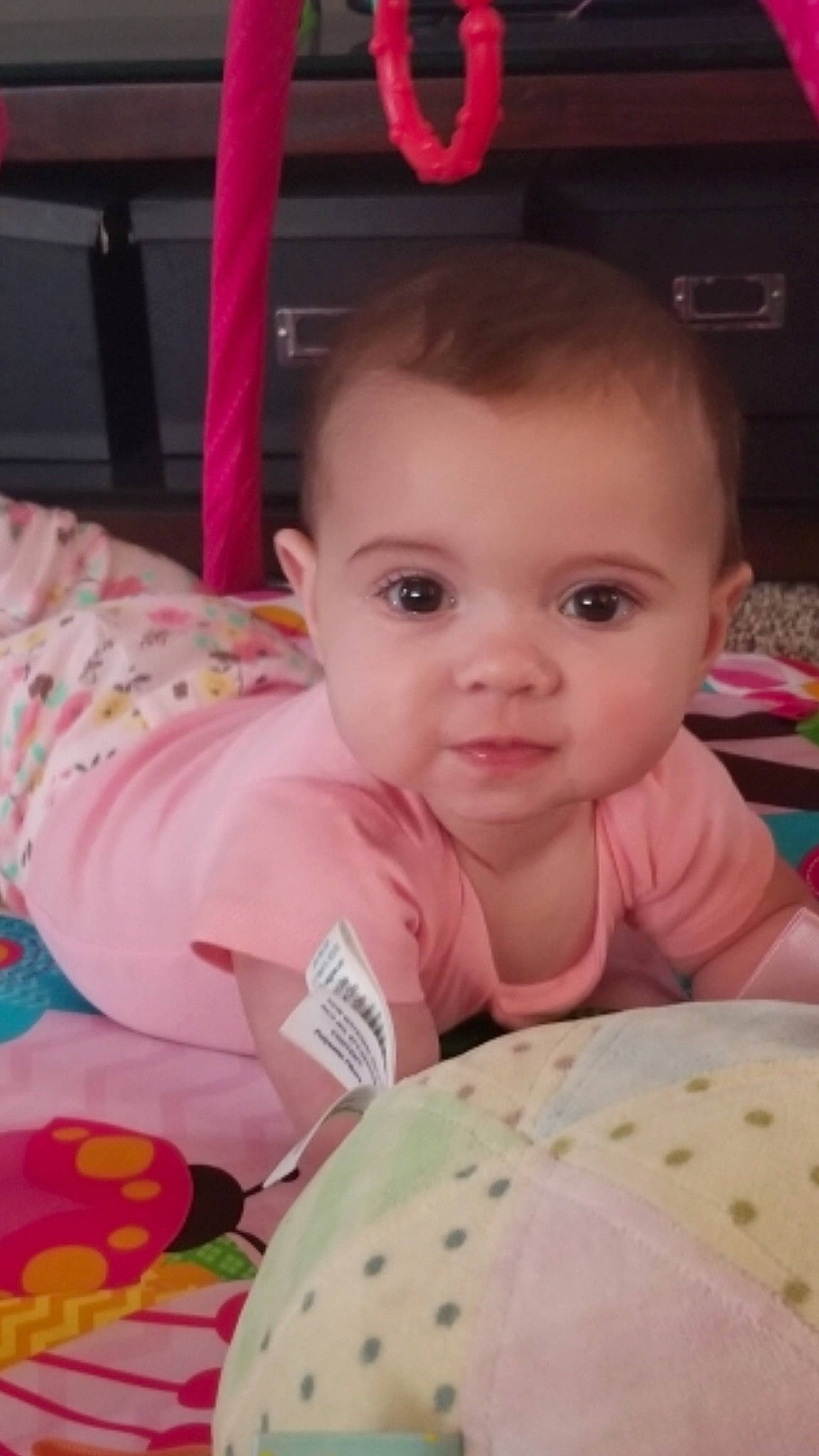 Bria is registered to the contest to win money with this photo: baby, baby_toddler_clothing, chair, cheek, child, event, eye, fun, happy, linens, pattern, person, pink, play, product, room, sitting, skin, smile, textile