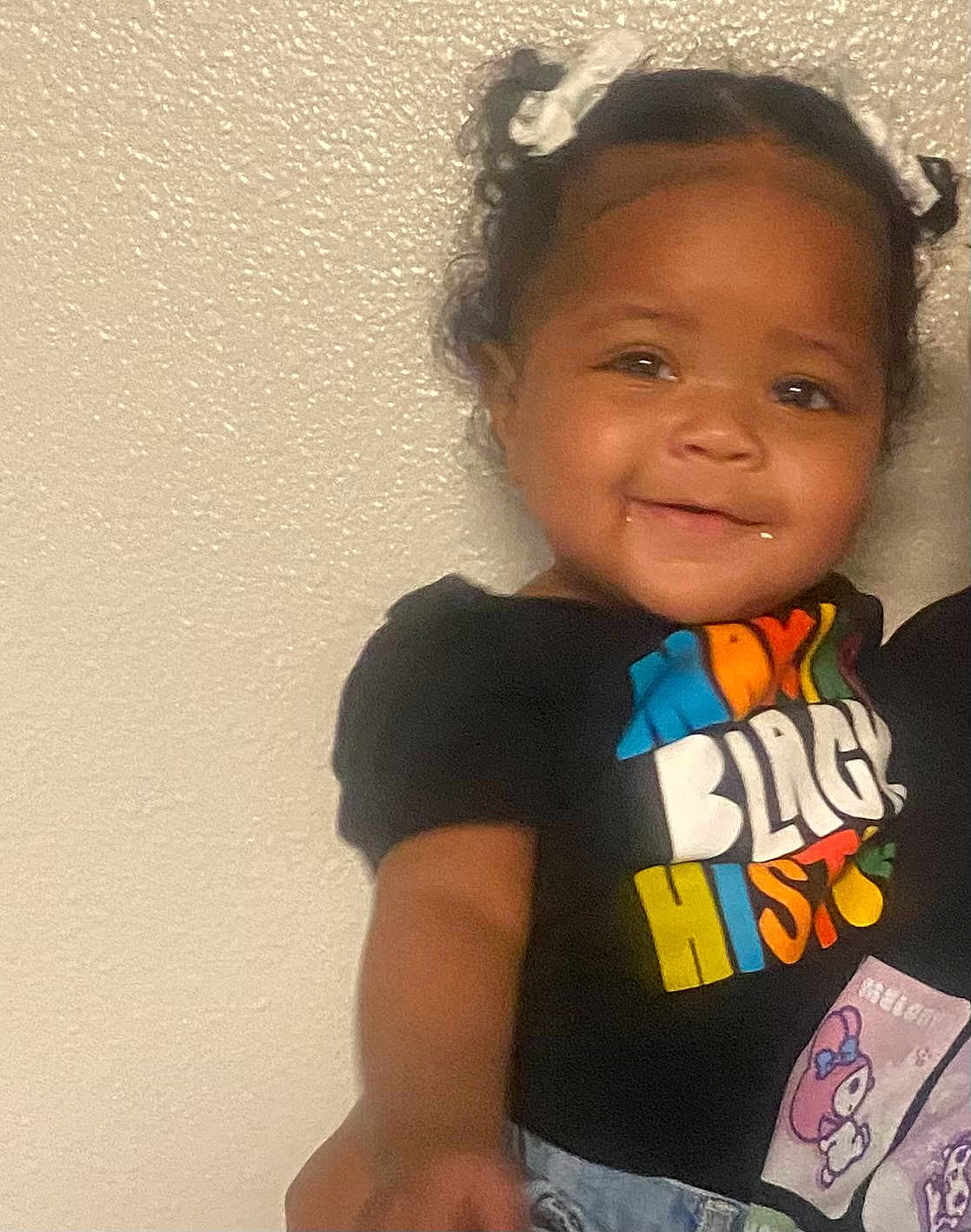 Jordan Lanae Jream joined the competition — help win amazing prizes! toddler, child, smiling, pigtails, bows, black_history, tshirt, colorful_text, jeans, standing, portrait, indoor, wall, cute, happy, person, face, young_child, short_sleeves, casual_clothing
