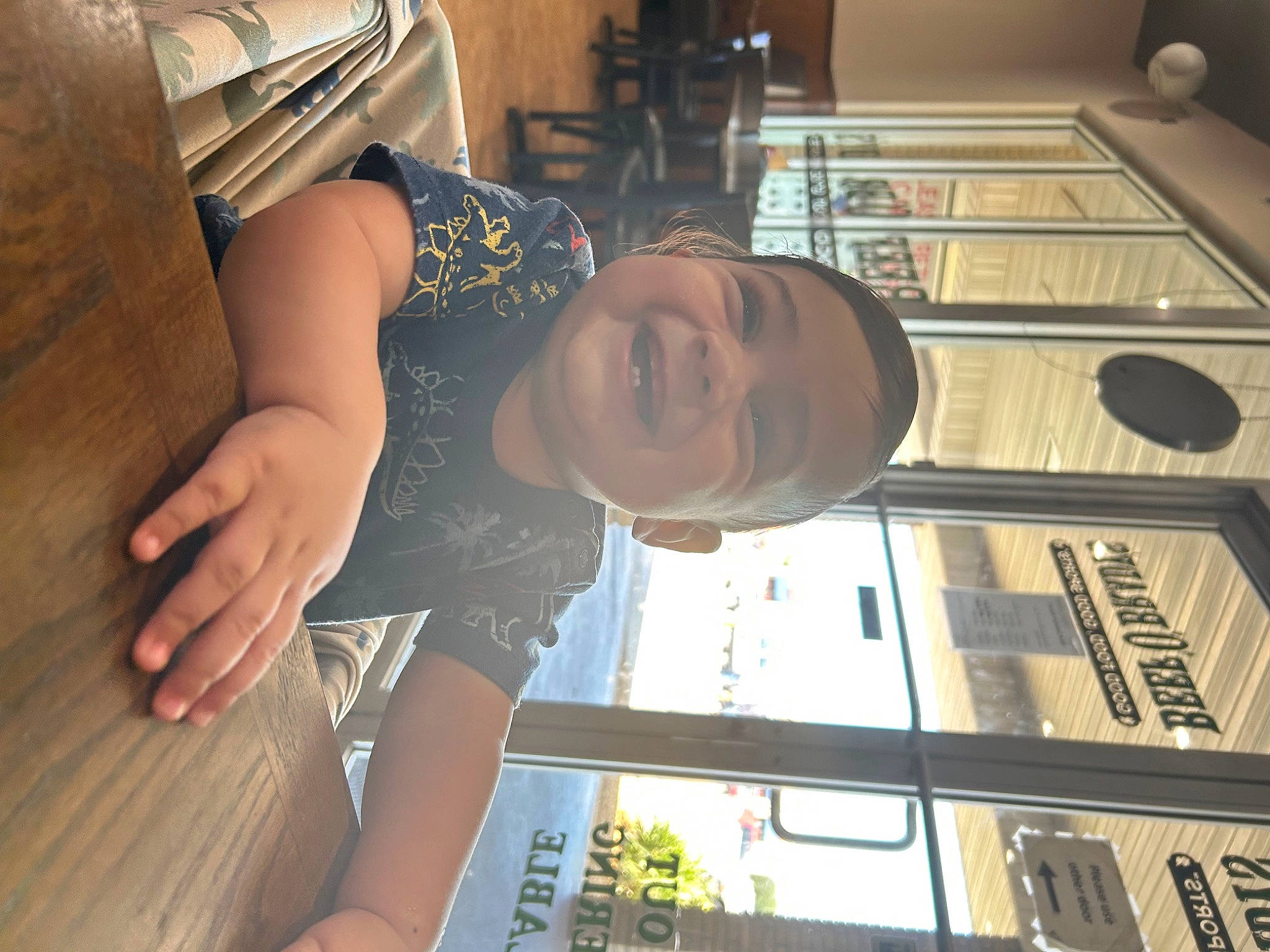 Dominic is registered to the contest to win money with this photo: building, elbow, eyewear, finger, fun, hand, joy, person, room, smile, snapshot, symmetry, thigh, thumb, vacation, window, wood