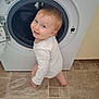 Arlo joined the competition — help win amazing prizes! toddler, child, washing_machine, laundry_room, white_onesie, curious, smiling, floor_tiles, appliance, indoors, baby, clothing, home, cute, happy, face, person, standing, machine_door, playful