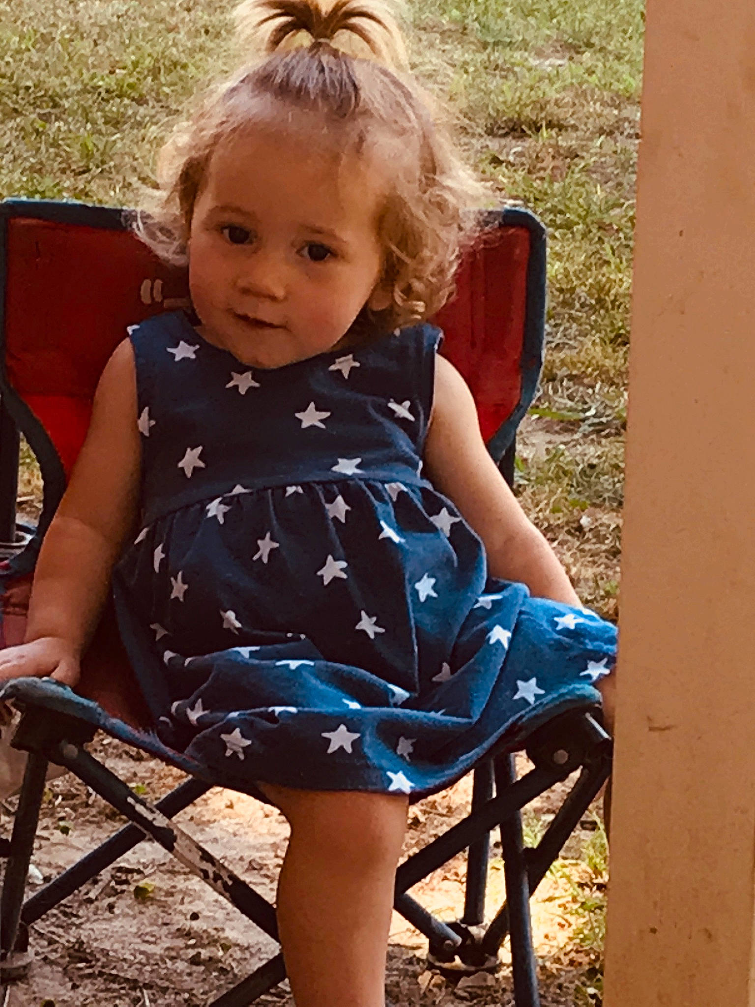 Lillie is registered to the contest to win money with this photo: baby_toddler_clothing, dress, eye, face, flash_photography, fun, grass, hair, hairstyle, happy, human_body, iris, leaf, people_in_nature, person, shoulder, skin, summer, sunlight, tints_and_shades