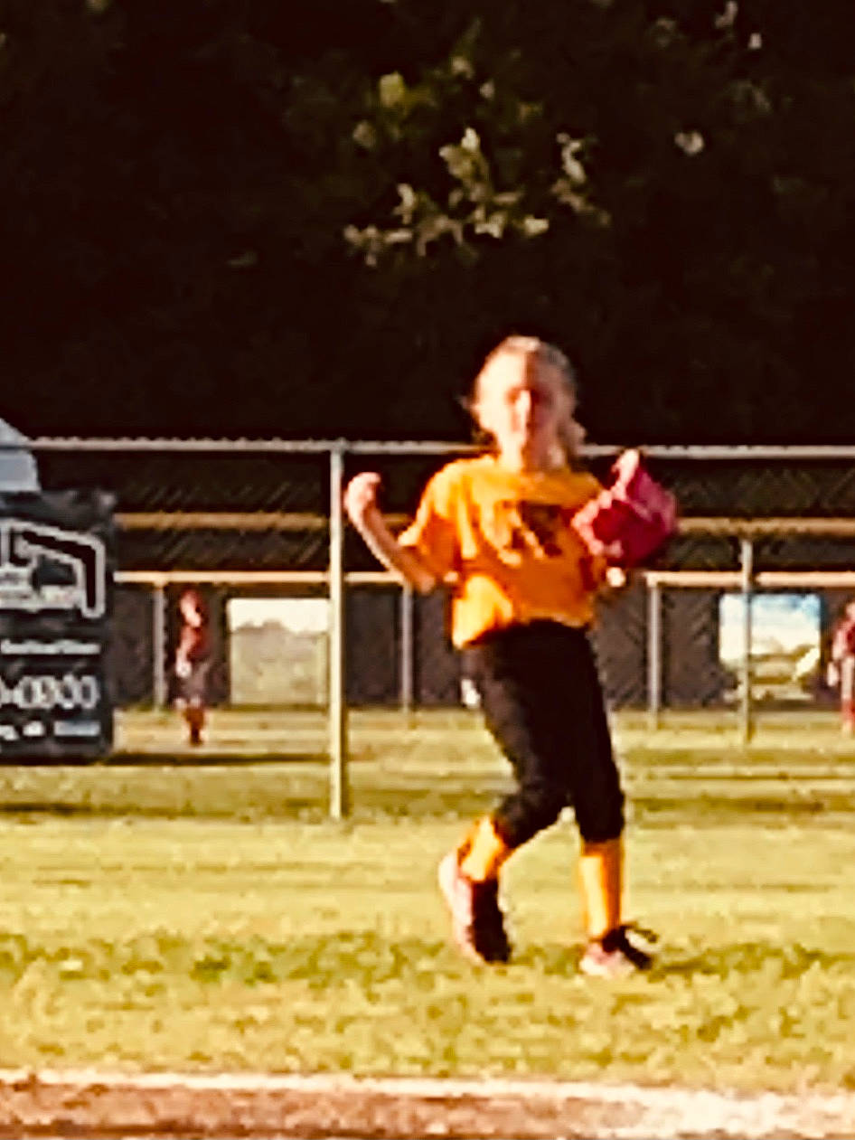 Callie is registered to the contest to win money with this photo: ball, ball_game, baseball_glove, child, competition_event, fence, footwear, grass, happy, leisure, person, play, player, recreation, shoe, sneakers, sports, sports_equipment, team_sport, toddler