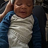 baby, infant, sleeping, hat, pajamas, person, hand, indoor, cozy, smile, child, clothing, comfort, relaxation, resting, skin, headwear, human, cute, peaceful